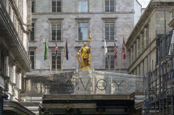 Count Peter of Savoy golden figure above entrance to The Savoy hotel, Strand, central London, England, UK