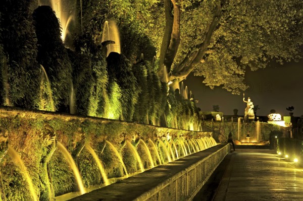 Avenue of a Hundred Fountains, Viale delle Cento Fontane, behind Fontana della Rometta, Renaissance garden of Villa d'Este, water features, fountains, atmospheric illumination at night, UNESCO World Heritage Site, Tivoli, metropolitan city of Rome, Lazio, Italy