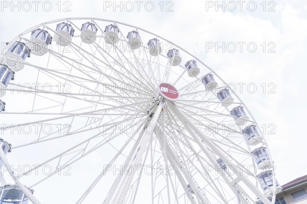 Beautiful Ferris wheel with illuminated gondolas in front of a clear sky, Ferris wheel construction, Calw, Germany