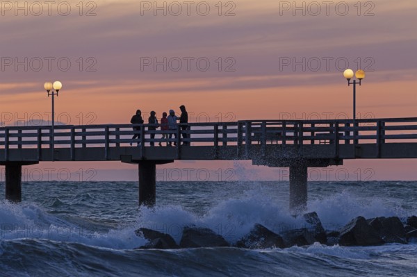 Sunset, pier, people, silhouettes, waves, swell, spray, street lamps, Wustrow, Fischland, Mecklenburg-Vorpommern, Germany