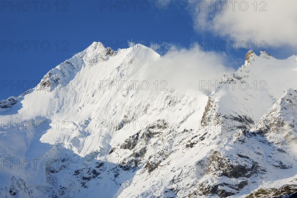 Freshly snow-covered summit of Piz Bernina and Biancograt, Engadin in the canton of Graubünden, Switzerland