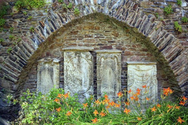 Remains of the town wall behind St Nicholas' Church with the gravestones of former priests of the town of Döbeln, Old Town, Döbeln, Saxony, Germany