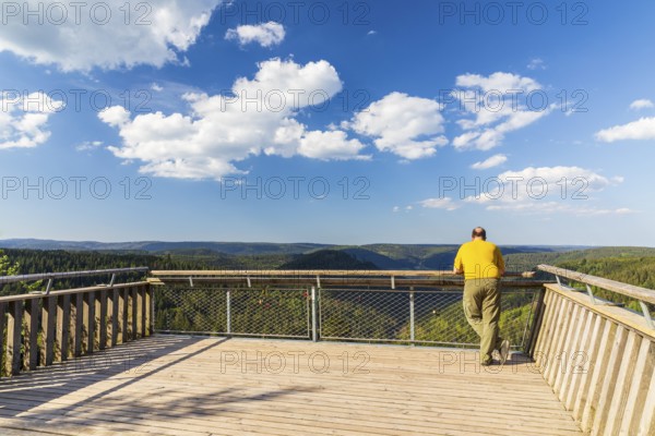 Man on the Ellbachseeblick viewing platform with a view over the wooded hills around Baiersbronn, Northern Black Forest, Baden-Württemberg, Germany