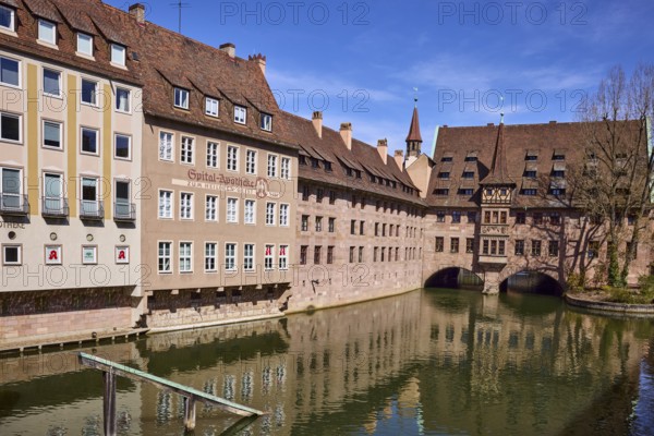 Heilig-Geist-Spital, historic hospital, pharmacy, river Pegnitz, historic buildings, facade, windows, trees, reflections, water surface, blue sky, cirrostratus clouds, Nuremberg, Middle Franconia, independent city, Bavaria, Germany
