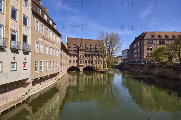 Heilig-Geist-Spital, historical building, river Pegnitz, facade, windows, trees, symmetrical reflections, water surface, blue sky, cirrostratus clouds, Pfarrgasse, Nuremberg, Middle Franconia, independent city, Bavaria, Germany