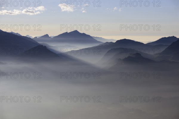Mountain silhouettes... Alpine peaks and mountain ranges in the Bavarian Alps, light fog rises from the valleys, which creates an idyllic atmosphere in the light of the low sun, romantic view from Oberstdorf towards Kleinwalsertal, local nature, Bavaria, Allgäu, Allgäu Alps, Bavarian, Germany, Western Europe