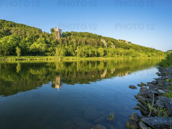 Prunn Castle on a steep cliff above the Altmühl Valley in the evening light, reflection in the river Altmühl as part of the Main-Danube Canal, near Riedenburg, Altmühl Valley nature park Park, Lower Bavaria, Germany