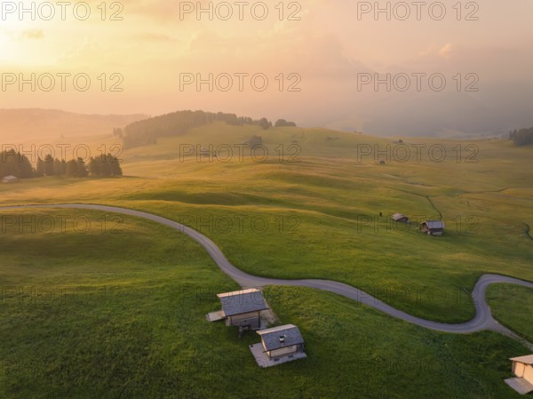 Hilly landscape at dusk in a harmonious atmosphere, Alpe di Siusi, Dolomites, South Tyrol, Italy