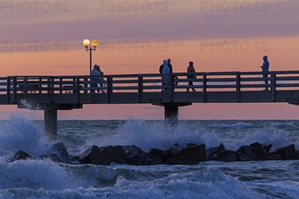 Sunset, pier, people, silhouettes, waves, swell, spray, street lamps, Wustrow, Fischland, Mecklenburg-Vorpommern, Germany