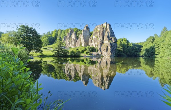 The Externsteine, a sandstone rock formation around 40 metres high in the Teutoburg Forest, are a natural landmark and a protected natural and cultural monument. They are regarded as a place of power and are said to have special cultural and historical significance. The rocks are located by the Wiembecketeich pond. Horn-Meinberg, North Rhine-Westphalia, Germany