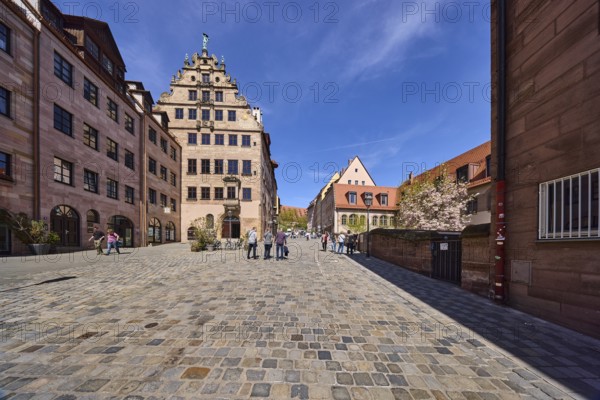 City museum in the Fembo House, historical merchant's house, building, general architecture, street of cobblestones, pedestrian as secondary motif, blue sky, cirrostratus clouds, Burgstraße, Nuremberg, Middle Franconia, independent city, Bavaria, Germany