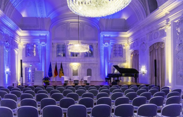 New Palace, White Hall. Interior view of the historic ballroom with festive lighting and rows of chairs. Stuttgart, Baden-Württemberg, Germany