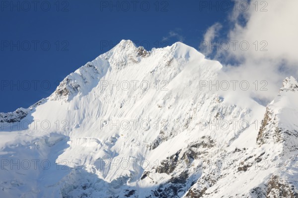 Freshly snow-covered summit of Piz Bernina and Biancograt, Engadin in the canton of Graubünden, Switzerland