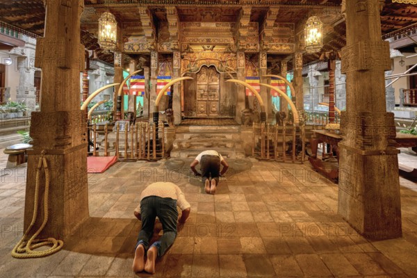 Pilgrims praying in front of the Holy Shrine, Temple of the sacred Tooth Relic or Sri Dalada Maligawa, Kandy, Sri Lanka