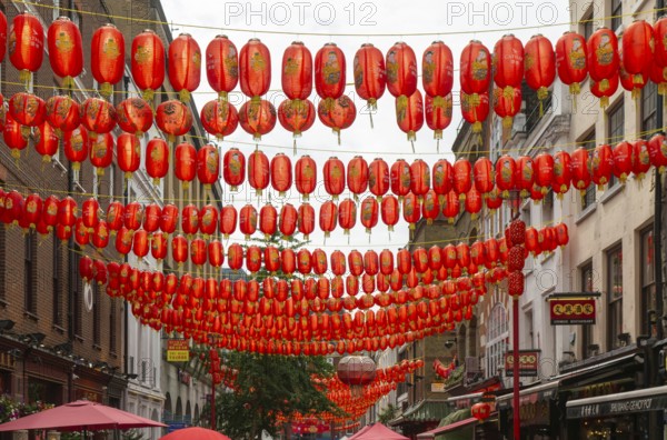Red Chinese lanterns crossing above Gerrard Street, Chinatown, West End, London, England, UK