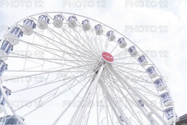 Large Ferris wheel with white gondolas and a sunny sky as a backdrop, Ferris wheel construction, Calw, Germany