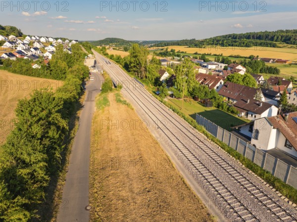 View of a railway line winding through a rural village and agricultural fields, construction of the Hermann Hesse Railway, Calw, Germany