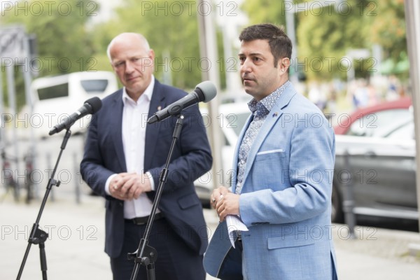 Kai Wegner (Governing Mayor of Berlin) and Florian Winkler-Schwarz, Managing Director of the Lesbian and Gay Federation (LSVD) Berlin Brandenburg in front of the raising of the rainbow flag for Pride Week in front of the Rotes Rathaus in Berlin on 9 July 2025