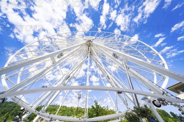 View from below of a partially erected Ferris wheel with a blue, cloudy sky, Ferris wheel construction for the 950th anniversary of the town of Calw, Black Forest, Germany