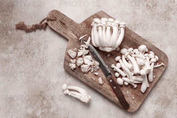 Freshly sliced Shimizhi mushrooms, on a wooden chopping board, ready to cook, close-up, no people