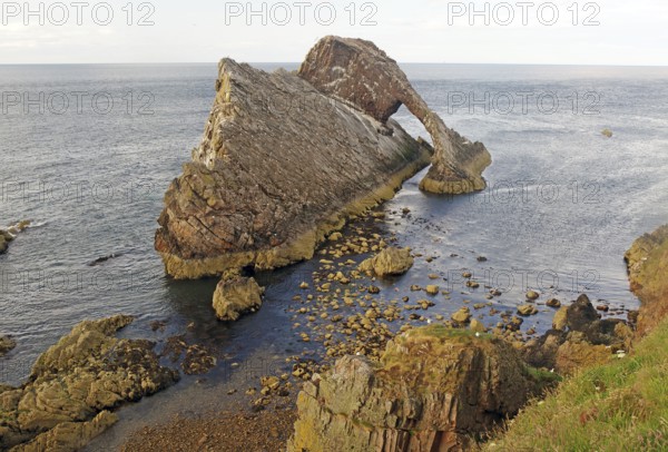 Impressive coastal view of a rock formation reaching far into the sea, Bow Fiddle Rock, Aberdeenshire, Buckie, Scotland, Great Britain