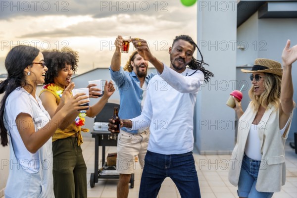Cheerful friends toasting and dancing together at a vibrant rooftop party, enjoying drinks and laughter as the sun sets over the city