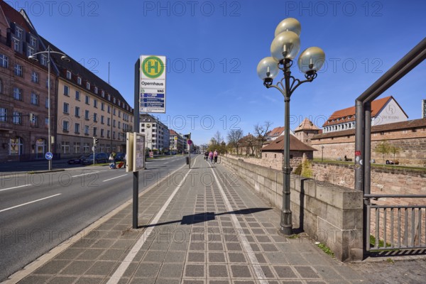 Bus stop opera house, public transport, footpath and cycle path, lantern, general architecture, city fortification, city wall, blue sky, cloudless, Frauentorgraben, Nuremberg, Middle Franconia, independent city, Bavaria, Germany