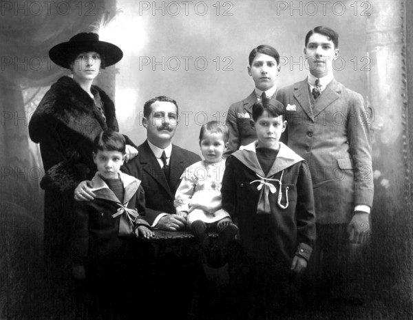 Family with 5 children, portrait of a family in traditional dress, formal group photo, historical photo