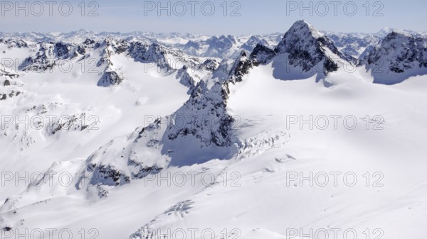winter mountain landscape in the Silvretta mountain range in the Swiss Alps with famous Piz Buin mountain peak in the center on a beautiful day