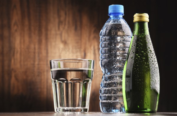Composition with glass and bottles of mineral water