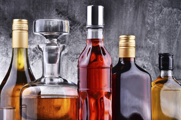 Composition with carafe and bottles of assorted alcoholic beverages