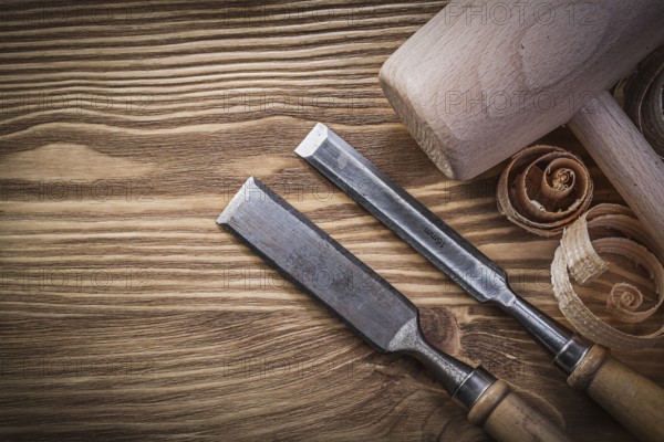 Carpenter's chisel and shavings on wooden board