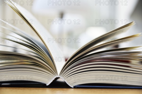 Hardcover book lying on the table in a library