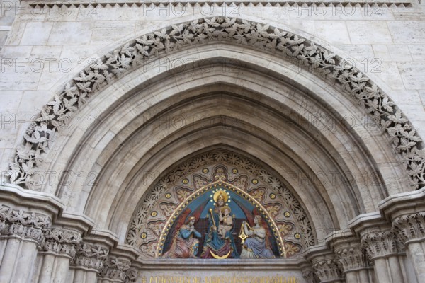 19th century bas-relief of the Madonna with Child between two angels on the Matthias Church tympanum in Budapest, Hungary