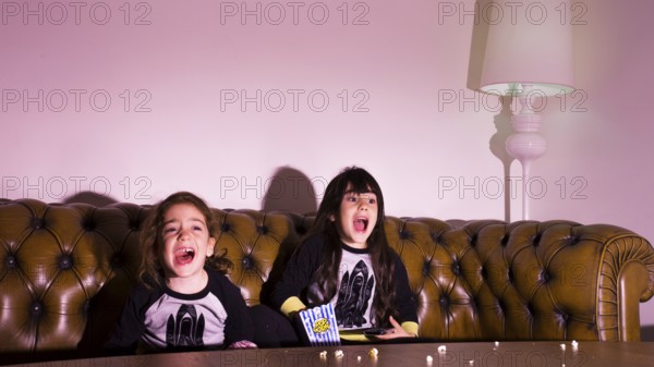 Scared kids watching movie home