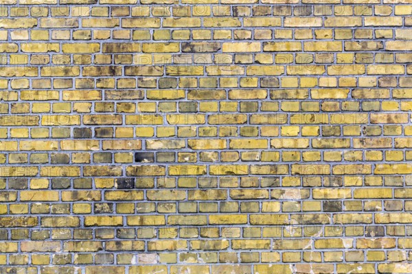 Old yellow brick wall for backgrounds