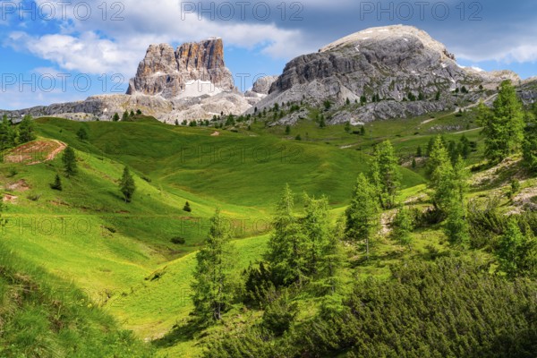 Natural landscape of Italian Dolomites Mountain with Mount Averau of the Nuvolau Group and green grass valley in Province of Belluno, Italy