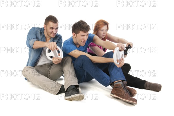 Three young friends ar gaming with the computer