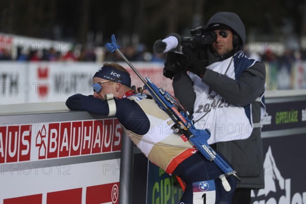 Ready to go, the new pursuit world champion Johannes Thingnes Boe Norway has to lean on the railing after crossing the finish line at the IBU Biathlon World Championships Lenzerheide 2025, Lenzerheide, Switzerland / SUI / CH