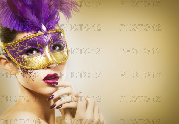 Beautiful woman with dramatic mekaup and pruple lipstick wearing puprle mask. Light background. Golden, Toronto, Canada