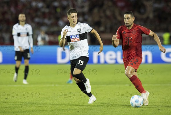 Football match, Raphael GUERREIRO FC Bayern Munich right on the ball in a duel with Jonathan MEIER SSV Ulm, football stadium Donaustadion, Ulm, Germany