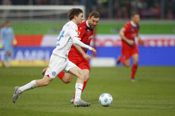 Football, Bundesliga 1, Matchday 26, 2024/2025, 1. FC Heidenheim vs. Holstein Kiel, 16.03.2025, Voith-Arena, Heidenheim, Germany, Magnus KNUDSEN (Holstein Kiel, 24) in duel with Benedikt GIMBER (1. FC Heidenheim, 05)