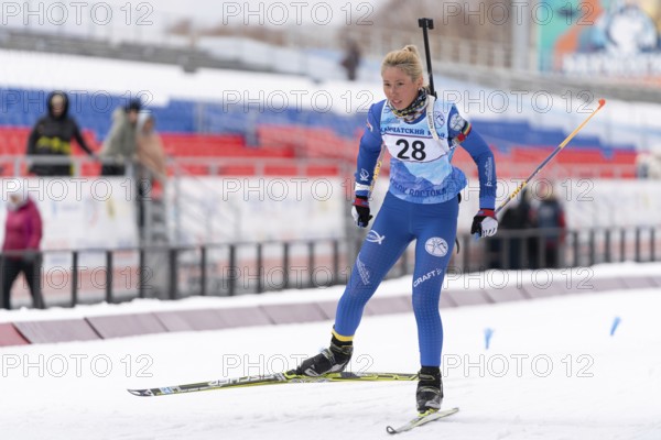 Sportswoman biathlete Petrunova Kseniya Kamchatka Region skiing on distance biathlon stadium. Open regional youth biathlon competitions East Cup. Kamchatka Peninsula, Russian Far East, Apr 12, 2019