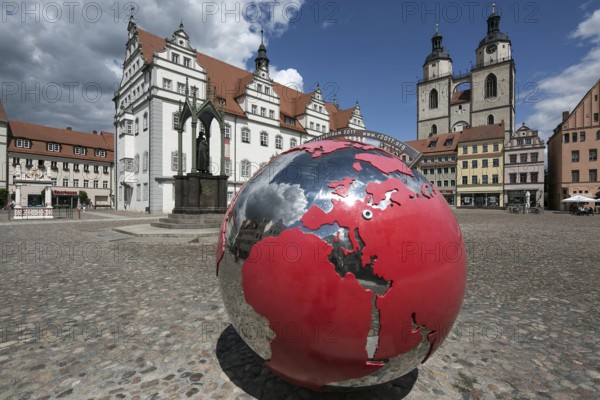 Luther city Wittenberg market square 6361 left town hall 16th century in front monument to Melanchton right towers of the town church 13th-16th century in front Reformation anniversary globe