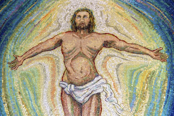 Religious mosaic of Jesus Christ, with open arms and eyes to the sky. The painting is multicolored. It can be used for backgrounds or concepts