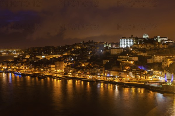Overview of Old Town of Porto, Portugal at night. Ribeira and Douro river