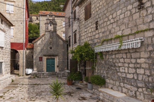 Perast, Montenegro, September 21, 2023: View of the historic town at famous Bay of Kotor with old houses and St. John the Baptist church