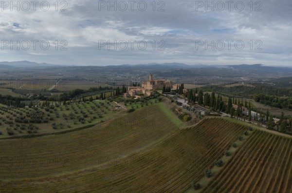 Montalcino, Italy, 16 November, 2023: aerial view of the Poggio alle Mura Castle and Villa Banfi wine resort in Tuscany