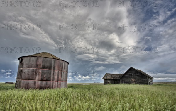 Abandoned Farm with storm clouds in the Canadian Prairie