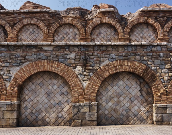 Old stone wall with brick arches antique rustic architectural texture